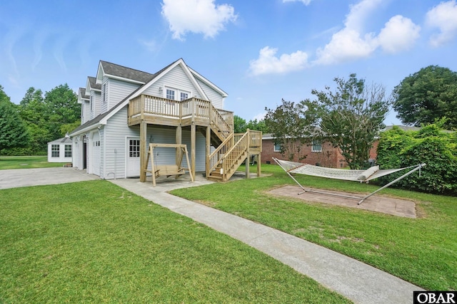 184 Tabernacle Ln, Aydlett, NC 27916 - rear view of house featuring a garage, a wooden deck, stairs, driveway, and a yard