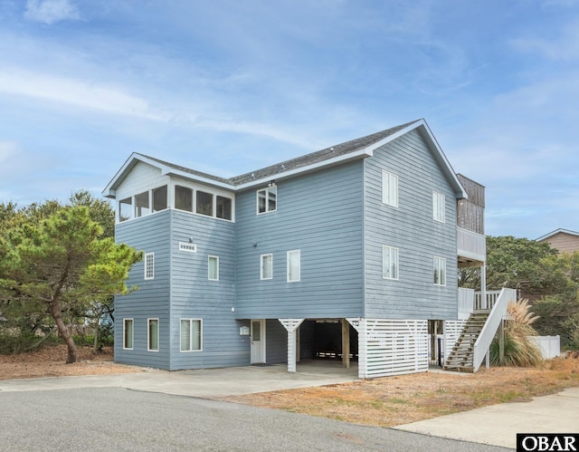 630 Skimmer Ct Lot 20, Corolla, NC 27927 - view of side of home featuring a carport, stairs, and driveway