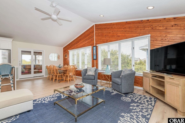 630 Skimmer Ct Lot 20, Corolla, NC 27927 - living room with healthy amount of natural light, wooden walls, vaulted ceiling, light wood-style flooring, and ceiling fan