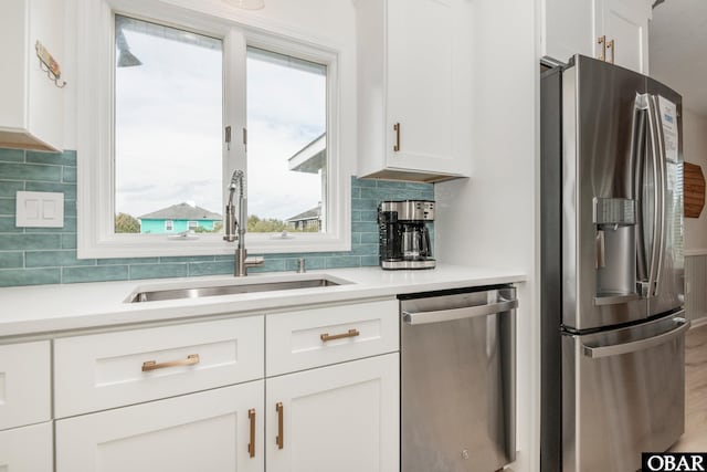 630 Skimmer Ct Lot 20, Corolla, NC 27927 - kitchen with appliances with stainless steel finishes, a sink, white cabinetry, and light countertops