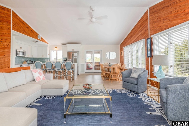 630 Skimmer Ct Lot 20, Corolla, NC 27927 - living area featuring ceiling fan, vaulted ceiling, wooden walls, and light wood finished floors