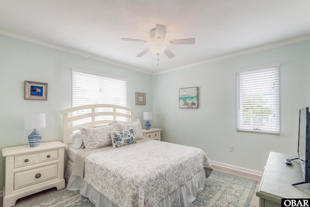 630 Skimmer Ct Lot 20, Corolla, NC 27927 - bedroom featuring crown molding, multiple windows, wood finished floors, a ceiling fan, and baseboards