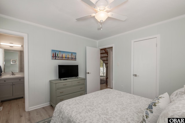 630 Skimmer Ct Lot 20, Corolla, NC 27927 - bedroom featuring ornamental molding, light wood-type flooring, a decorative wall, connected bathroom, and a sink