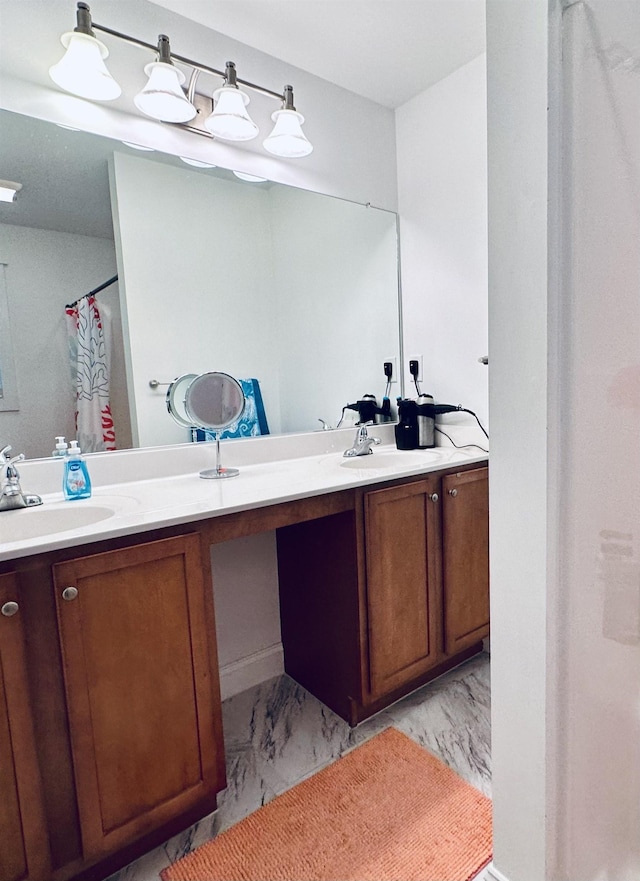 bathroom with curtained shower, marble finish floor, a sink, and double vanity