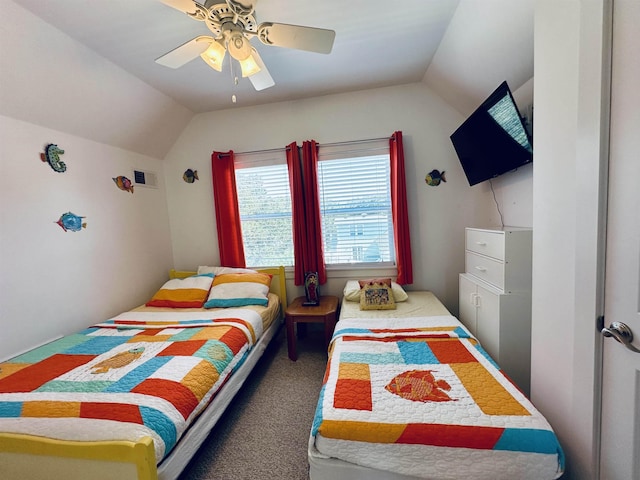 bedroom with dark carpet, vaulted ceiling, and a ceiling fan