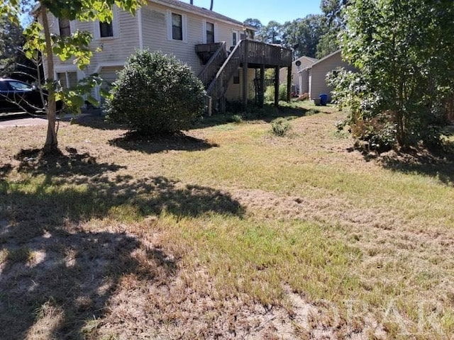 view of yard featuring stairs and a wooden deck