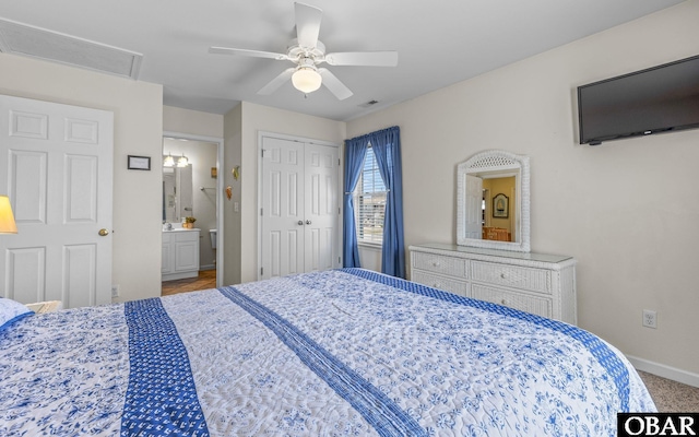 bedroom with baseboards, ceiling fan, ensuite bathroom, a closet, and carpet floors