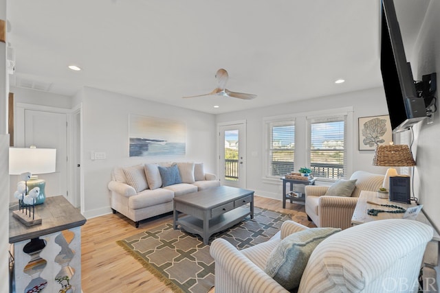 living area featuring baseboards, ceiling fan, recessed lighting, and light wood-style floors