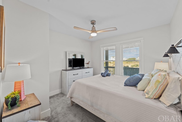 bedroom featuring a ceiling fan, light colored carpet, and baseboards