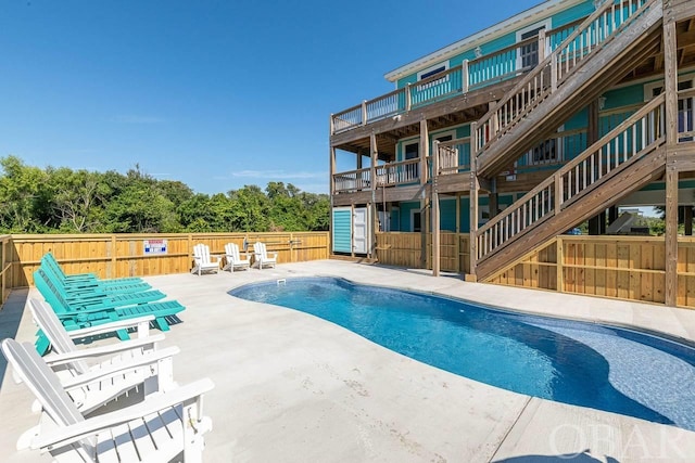 view of swimming pool with a patio area, a fenced backyard, stairs, and a fenced in pool