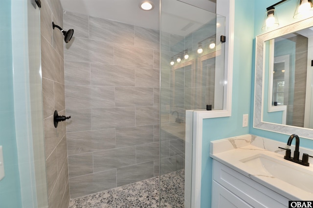 full bath with a shower stall and vanity