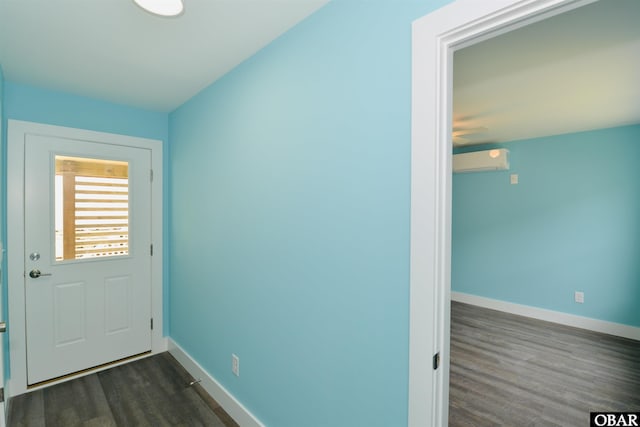 doorway with dark wood-type flooring, a wall mounted AC, baseboards, and a ceiling fan