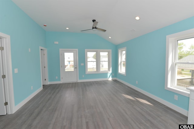 unfurnished living room featuring baseboards, vaulted ceiling, a ceiling fan, and wood finished floors