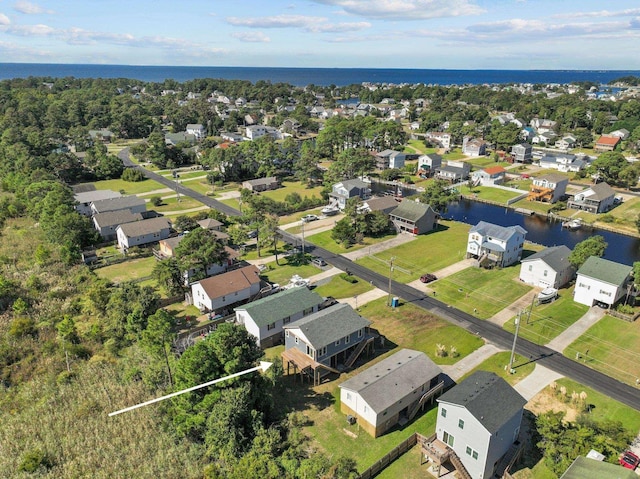 drone / aerial view featuring a water view and a residential view