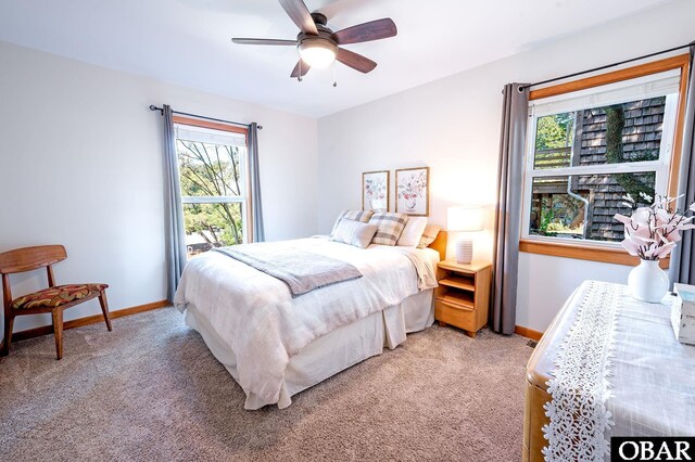 carpeted bedroom featuring ceiling fan and baseboards