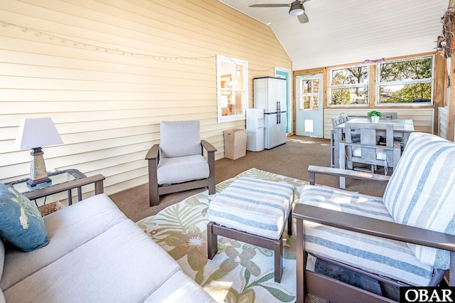 sunroom featuring a ceiling fan and vaulted ceiling