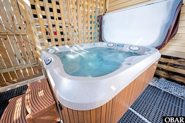 miscellaneous room with a jacuzzi, wood walls, and tile patterned floors