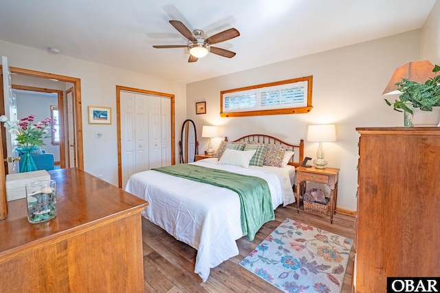 bedroom with ceiling fan, a closet, and wood finished floors