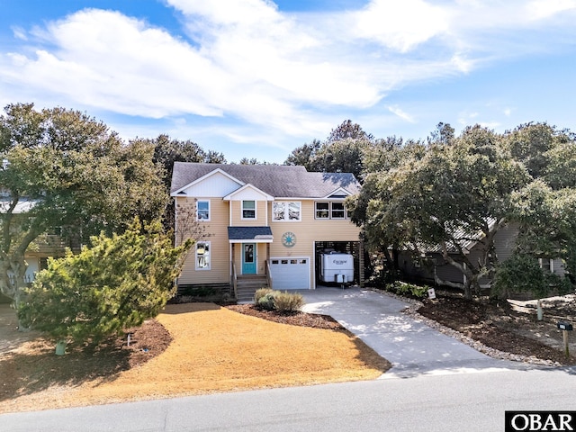 view of front of home featuring concrete driveway and an attached garage