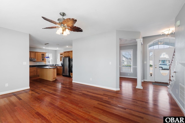 121 Bayside Dr Lot # 71, Moyock, NC 27958 - unfurnished living room with decorative columns, dark wood-style flooring, and a ceiling fan