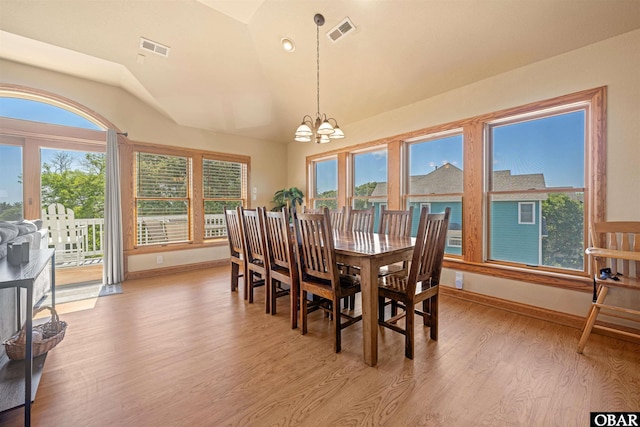 dining room with light wood-type flooring, visible vents, plenty of natural light, and vaulted ceiling