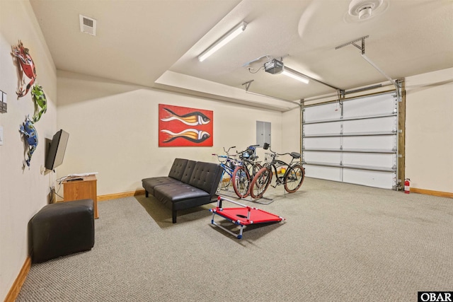 garage with electric panel, visible vents, a garage door opener, and baseboards