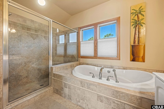bathroom featuring a bath, a shower stall, and lofted ceiling