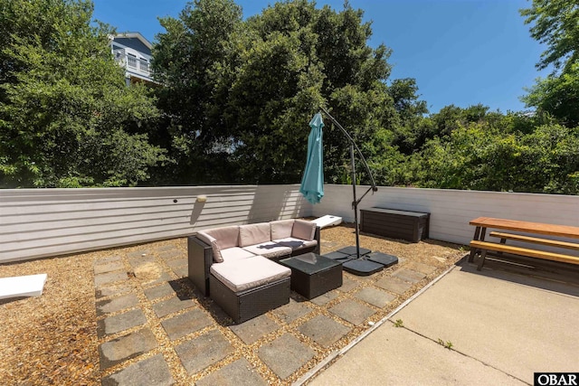view of patio / terrace featuring an outdoor living space and fence