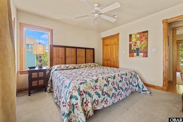 carpeted bedroom featuring a ceiling fan and baseboards