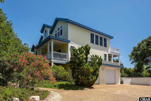 view of front of house with a garage and a balcony