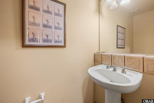 bathroom with a sink and visible vents