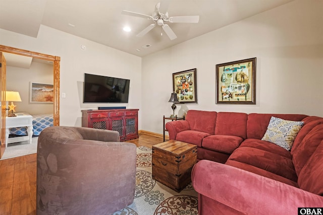 living room featuring recessed lighting, baseboards, wood finished floors, and a ceiling fan
