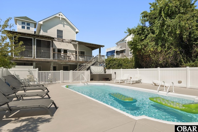 view of swimming pool featuring a fenced in pool, fence, stairway, and a patio