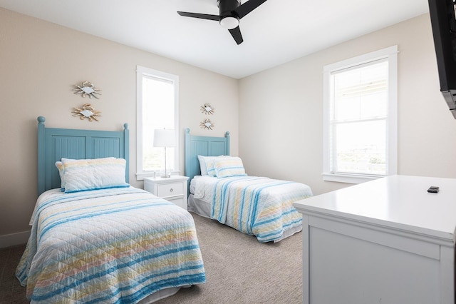 bedroom with a ceiling fan and light carpet