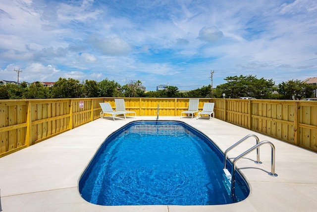 view of pool with fence, a fenced in pool, and a patio