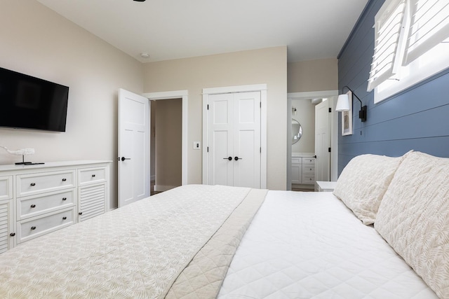 bedroom with a closet and ensuite bathroom