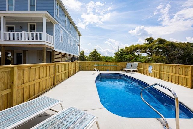 view of pool featuring a fenced in pool, a fenced backyard, and a patio