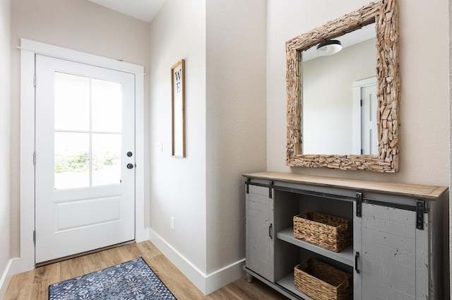 entryway featuring light wood-style flooring and baseboards