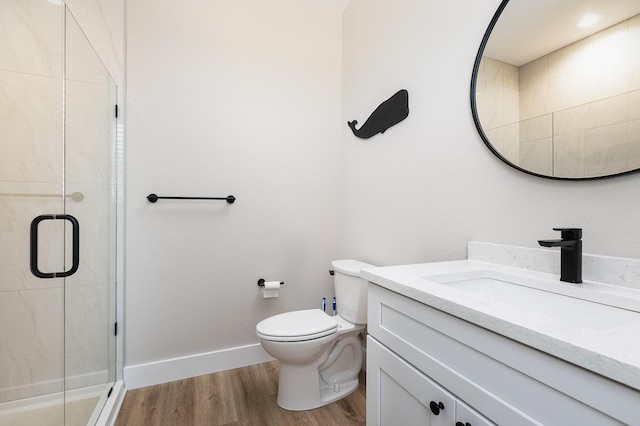 full bath with toilet, a shower stall, baseboards, and wood finished floors