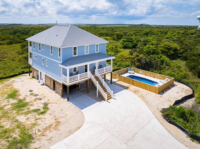 bird's eye view with a wooded view