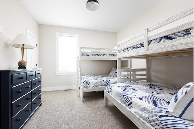 bedroom with light carpet and baseboards