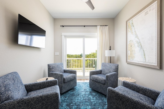 living area with ceiling fan and wood finished floors