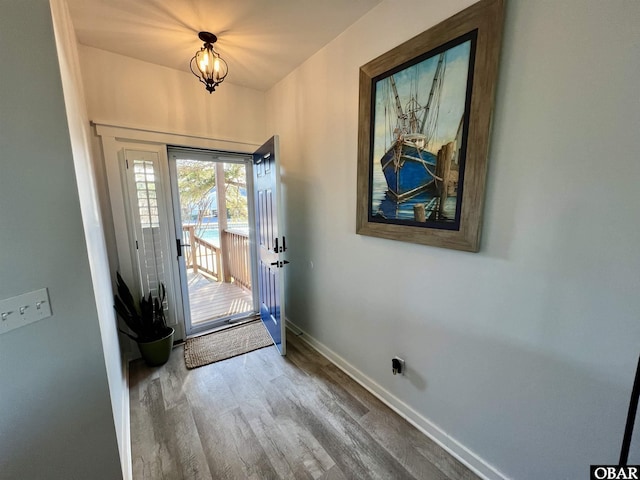 entryway with baseboards and wood finished floors