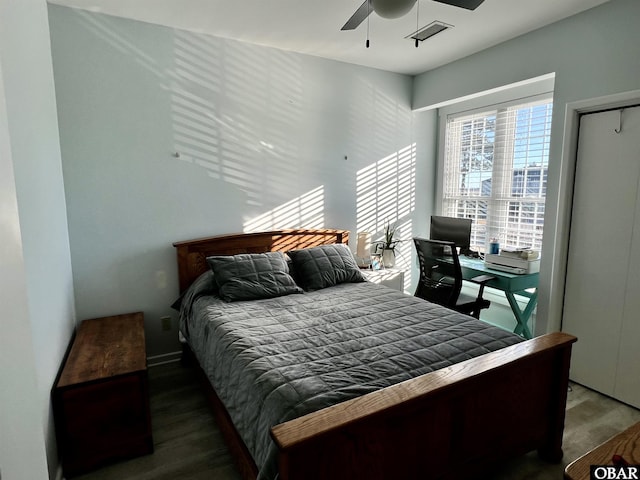 bedroom featuring ceiling fan, wood finished floors, and visible vents