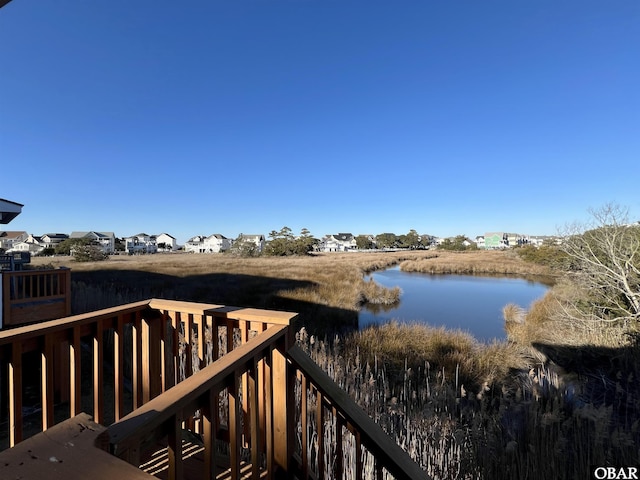 wooden terrace featuring a water view