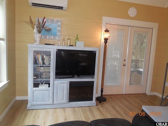 104 Sand Dollar Rd Lot # 23, Ocracoke, NC 27960 - living room featuring a wall unit AC, wood finished floors, wooden walls, and a fireplace