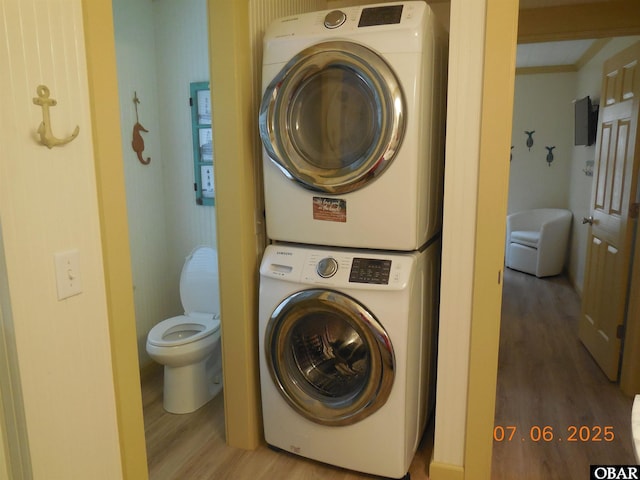 104 Sand Dollar Rd Lot # 23, Ocracoke, NC 27960 - laundry room featuring stacked washer and clothes dryer and wood finished floors