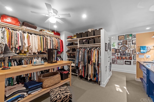 walk in closet with carpet, ceiling fan, and a sink