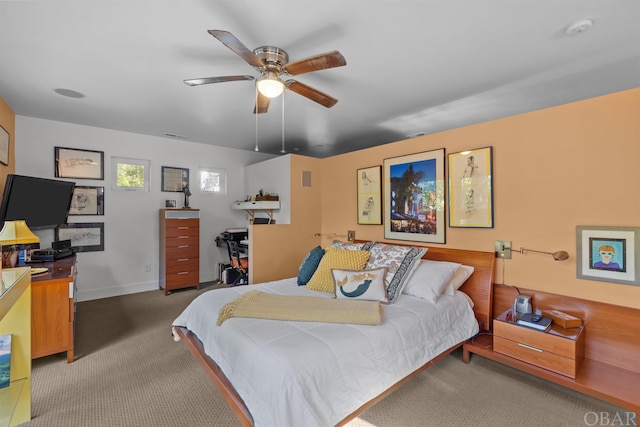 bedroom with ceiling fan, carpet flooring, and baseboards