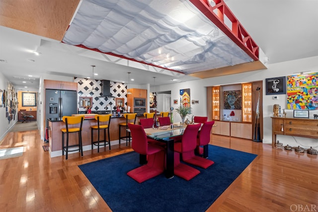 dining area with light wood-type flooring and recessed lighting